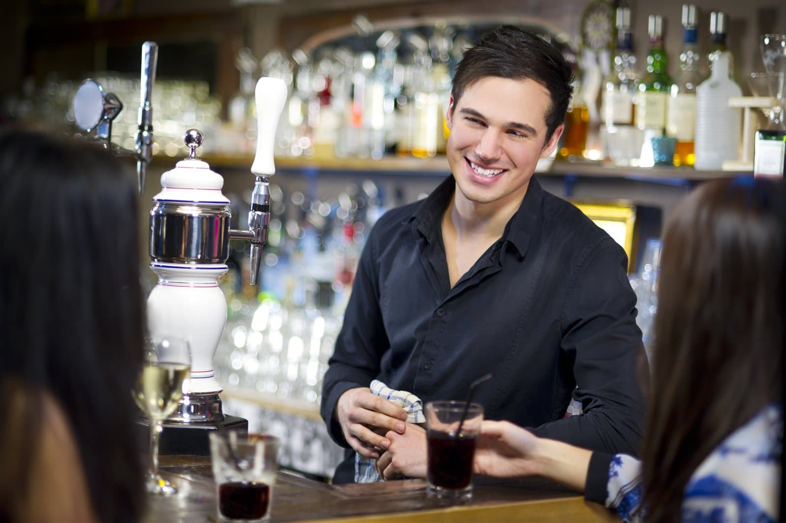 Bartender serving drinks in a licensed venue — RSA training at CBD College