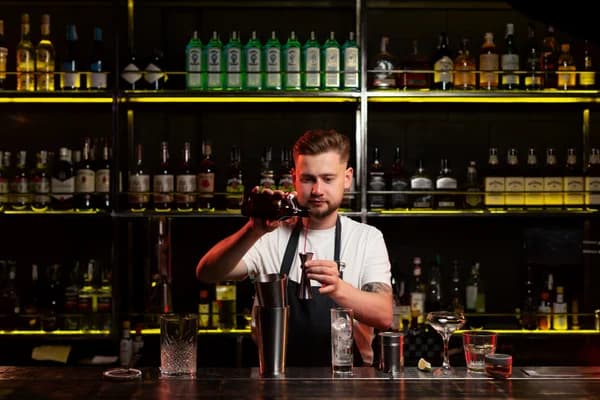 Bartender making a cocktail with a shaker — Bar Basics course at CBD College
