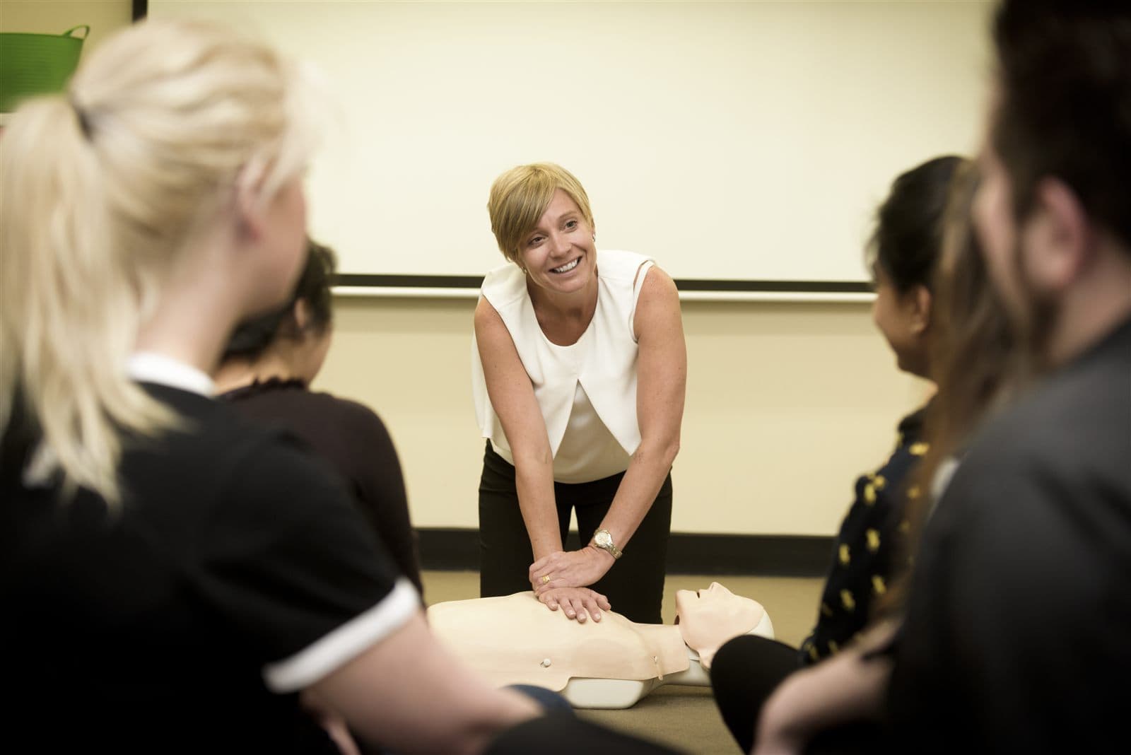 CBD College trainer demonstrating CPR compressions on a manikin