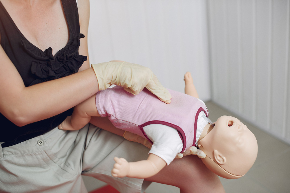Participants in a childcare first aid course learning CPR and emergency response techniques in Liverpool